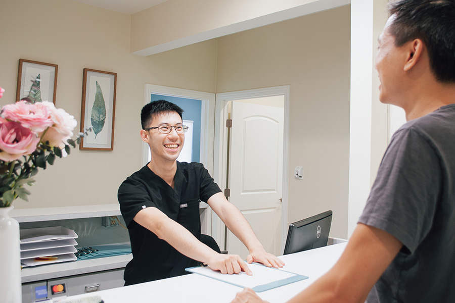Dr. Chung Talking to a Patient Customized dental care for each patient.